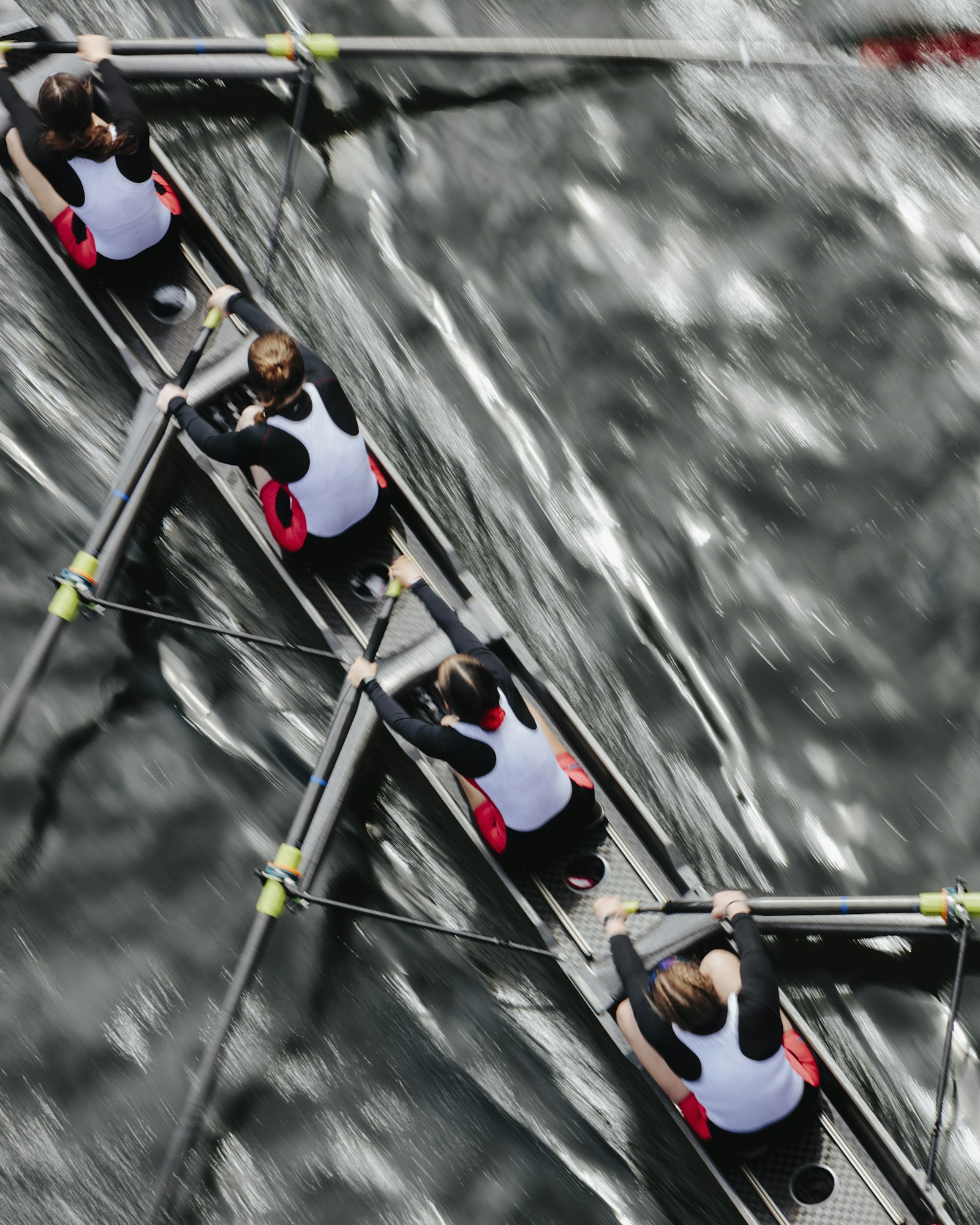 Overhead view of female crew racers rowing in an octuple racing shell, an eights team.