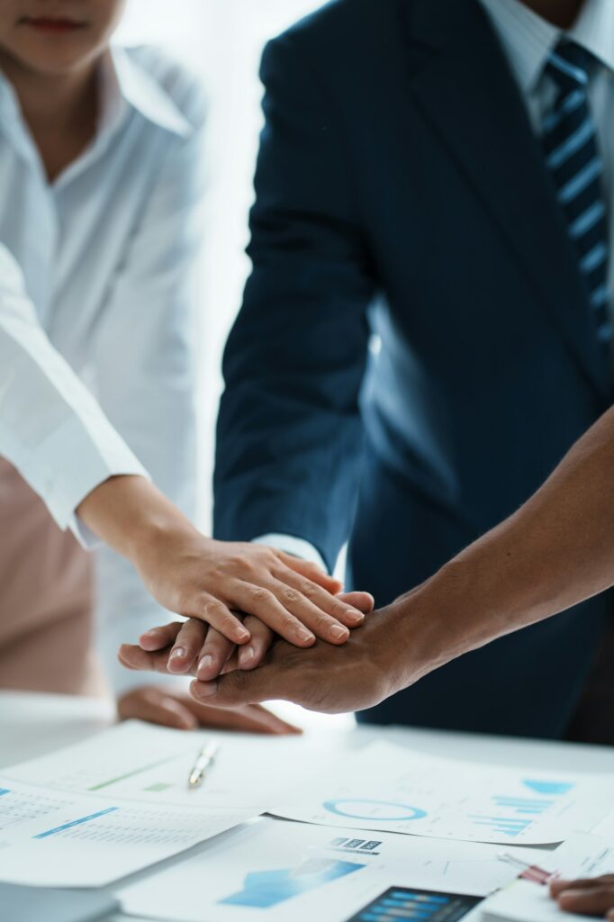 Young business people putting their hands together. Stack of hands. Unity and teamwork concept.